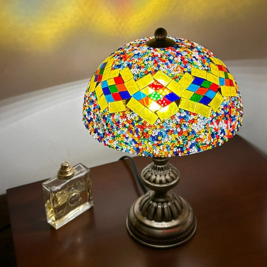 Homira colorful mosaic mushroom lamp on a wooden surface with a blurred background