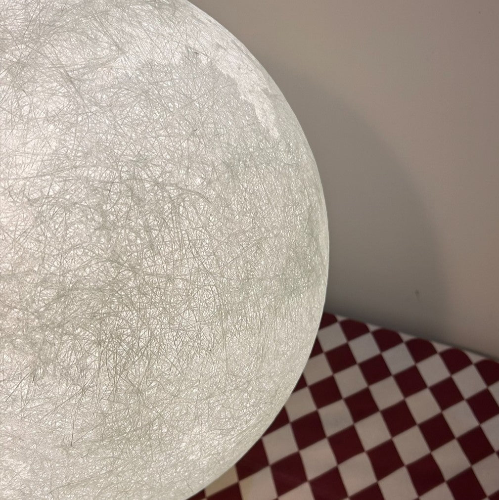 Close-up of a textured white moon lamp.