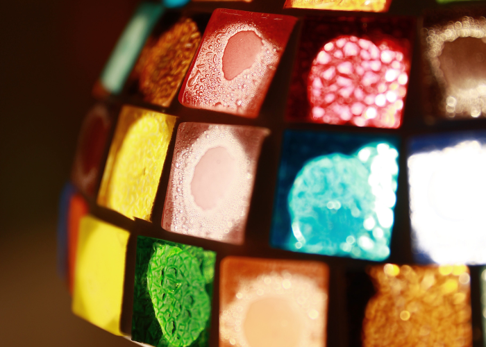 Close-up of a colorful makeup palette with various shades.