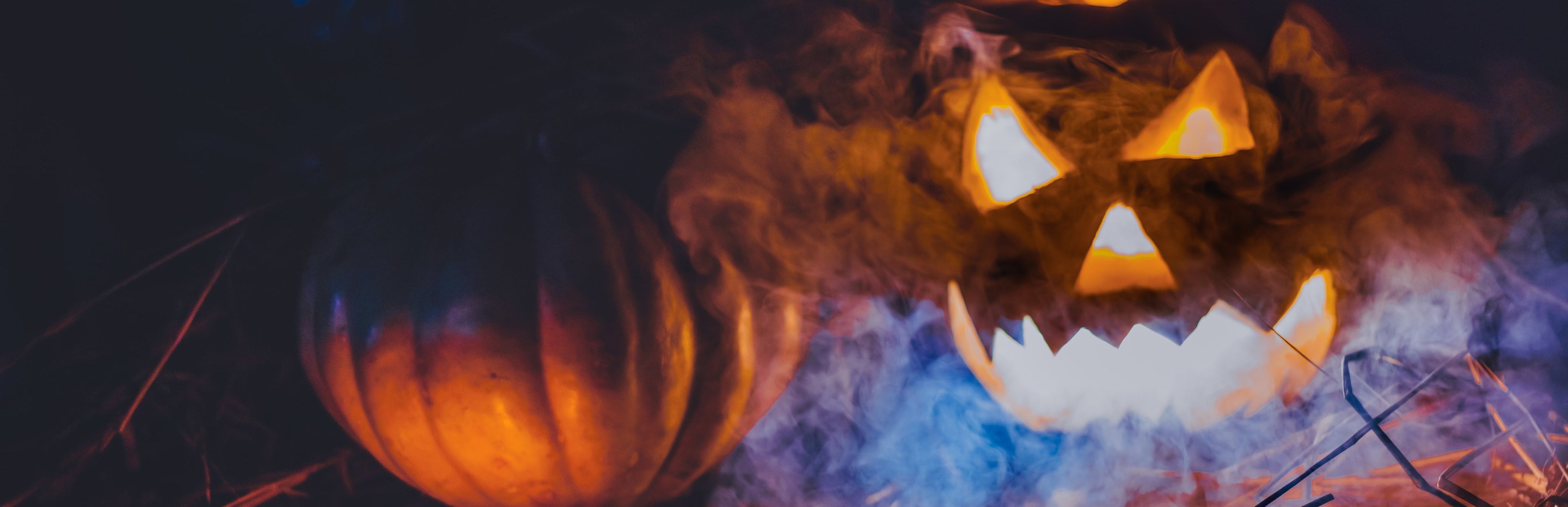 Two glowing jack-o'-lanterns with a dark background