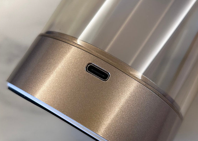 Close-up of a metallic device with a USB-C port on a blurred background