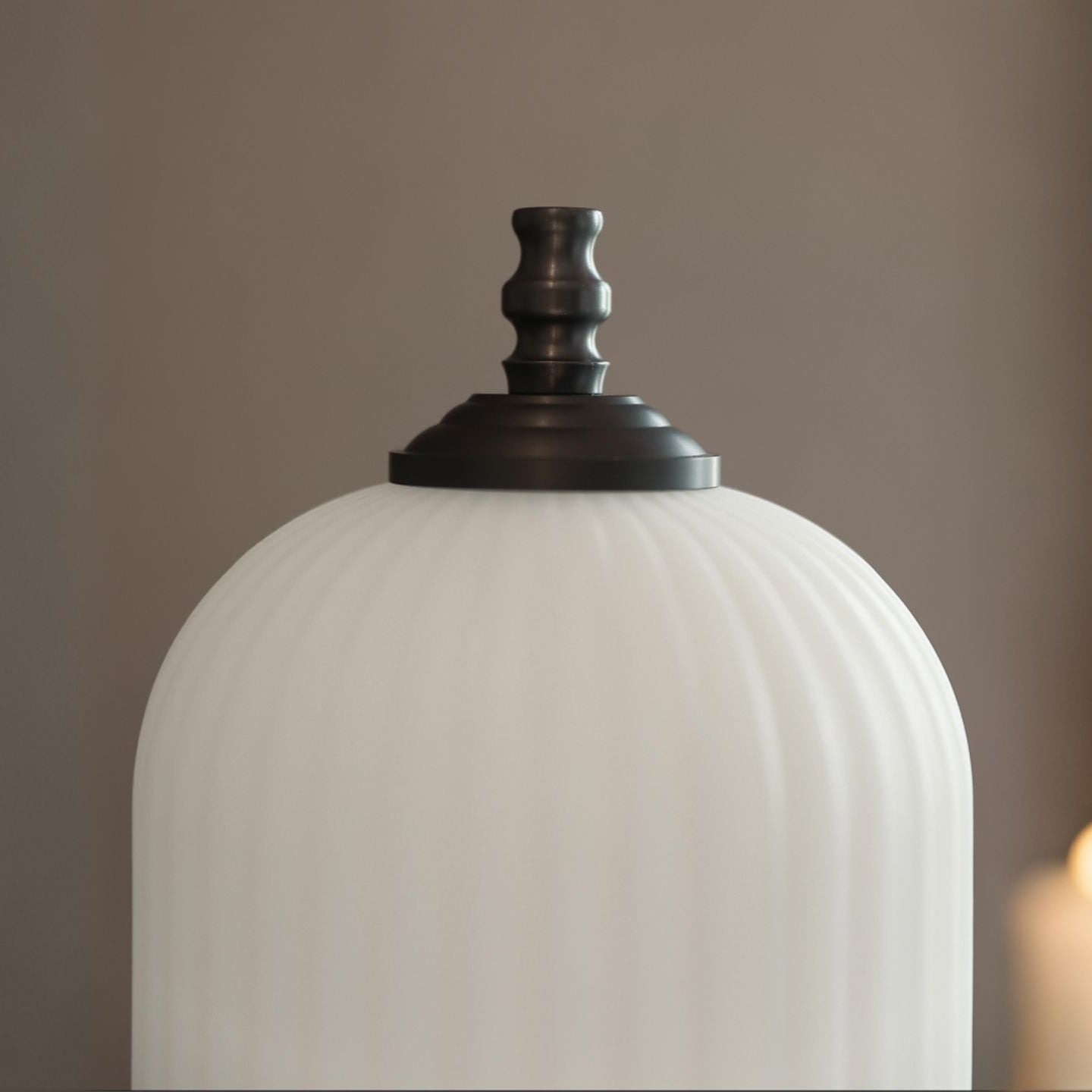 Homira Lantern Lamp  with a dark brown fixture on a blurred background