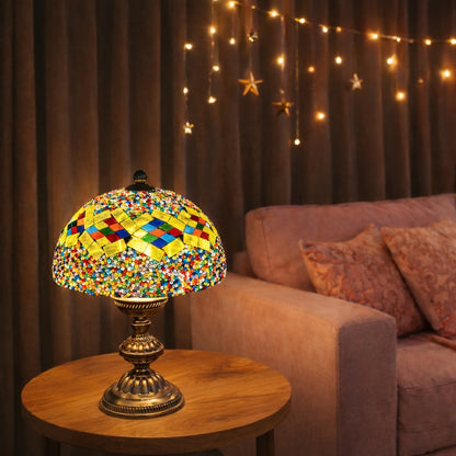 Multicolored mosaic lamp on a wooden table with a cozy living room background