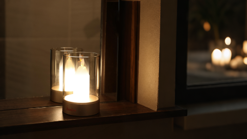 Homira candle lamp on a wooden surface with a blurred background